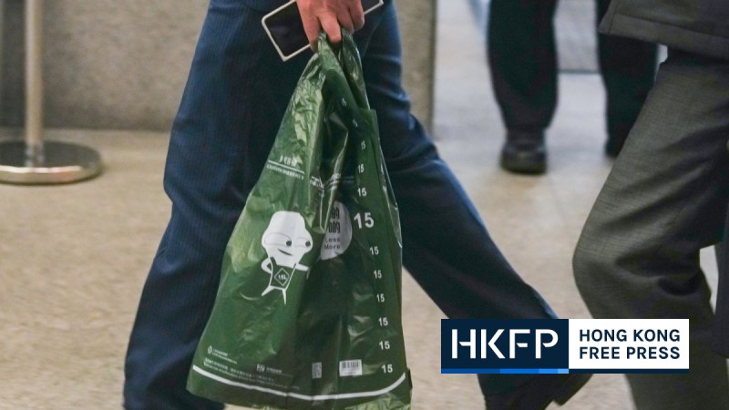 A person carrys a designated disposal bag authorised by the government under the new municipal solid waste charge scheme on January 26, 2024. Photo: Kyle Lam/HKFP.